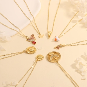 Detailed view of various 18K gold plated bird necklaces with zircon and enamel pendants