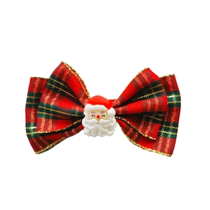 Christmas hair clip with a red plaid bow and a 3D Santa Claus figure for children