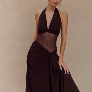 Detail of dark brown halter dress featuring sheer mesh waist and pleated skirt texture