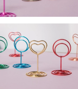 Close-up of heart and round metal wire memo clips in various vibrant colors