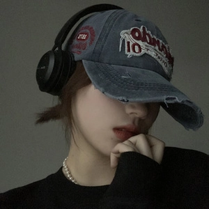 Close-up of vintage blue denim baseball cap with red and white 10 embroidery detail