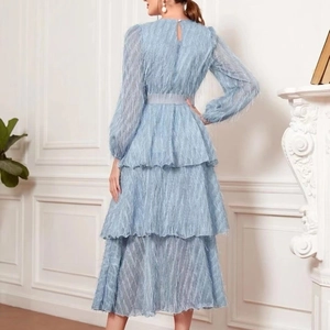 Back view of light blue tiered ruffle long sleeve dress with fringe texture and belt