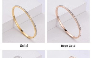 Detailed view of gold and rose gold bangles featuring sparkling zircon pavé settings