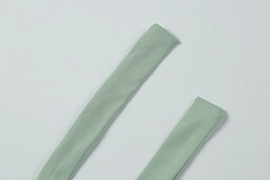 Detail of mint green ribbed knit straps showing the fine texture and quality stitching