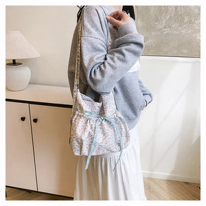 Floral nylon shoulder bag detail featuring sweet pink flower patterns and blue drawstring