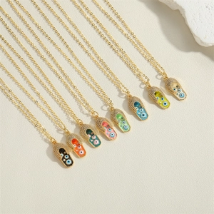 Detail of eight colorful evil eye sandal pendants on gold-plated chain necklaces