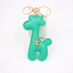 Detail of green PU leather giraffe keychain with gold ring and sparkling rhinestone charm
