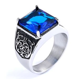 Macro shot of vintage stainless steel ring featuring blue stone and vine engraving