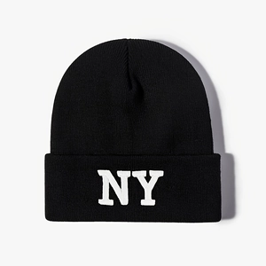 Detailed view of black knit beanie featuring thick texture and white NY embroidery