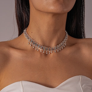 Detail of silver layered choker necklace featuring metallic beads and openwork geometric chain