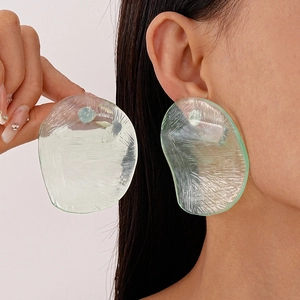 Close-up of translucent light green resin earring with irregular ice-crack texture