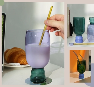 Detail of colorful heat-resistant glass cups with wavy bases and matching glass straws