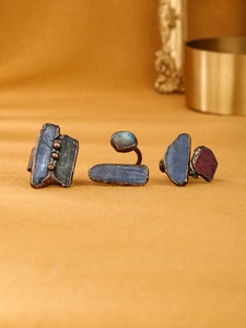 Detailed view of vintage bronze rings set with raw kyanite and labradorite stones