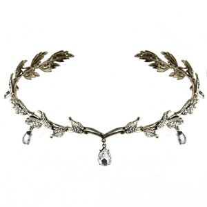 Close-up of vintage bronze bridal crown with leaf motifs and clear crystal teardrop pendants