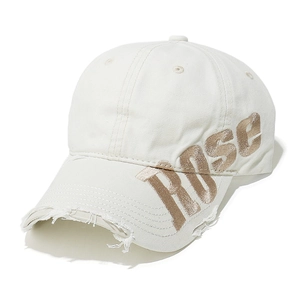 Detail of white baseball cap with gold ROSE embroidery and distressed frayed brim edges