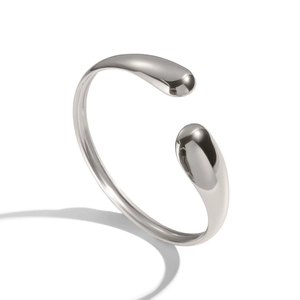 Macro detail of silver polished stainless steel cuff bracelet with teardrop design