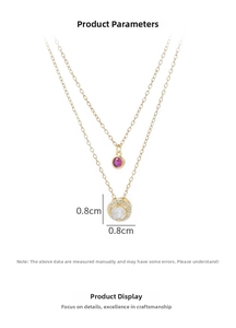 Close-up of dual-layer gold necklace featuring a red gem and 0.8cm zircon pendant