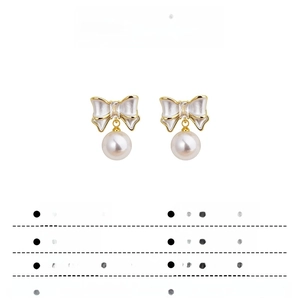 Detail view of gold-plated bow pearl earrings with dimensions and weight specifications