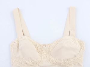 Detailed view of beige camisole featuring lace trim and textured fabric cups