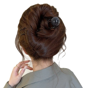 Épingle à cheveux rétro en U avec perle marbrée présentée sur un chignon
