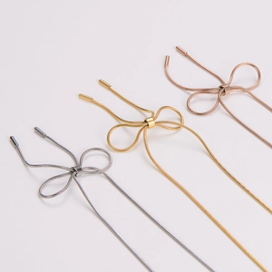 Bow tie necklaces in silver, gold, and rose gold finishes with snake chain texture