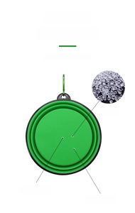 Detail of green collapsible pet bowl made of TPE material with a metal carabiner clip