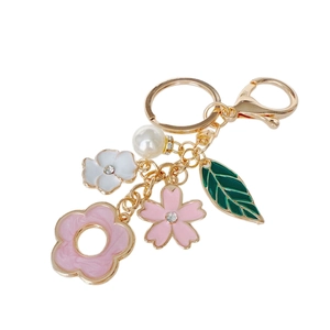 Floral keychain with rhinestones and pearls on a white background for bag charm