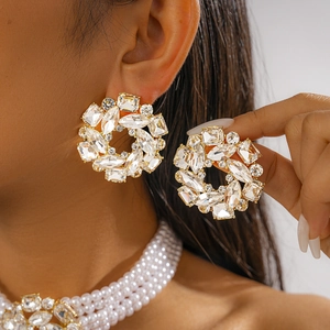 Close-up of luxury pearl choker and large round crystal stud earrings on model