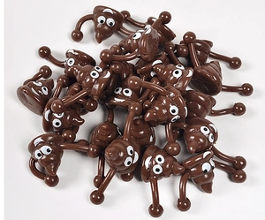 Close-up of funny brown poop emoji slingshot toys with smiling faces on white background
