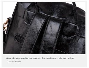 Close-up of black leather backpack with reinforced stitching and back zipper pocket