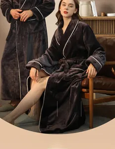 Detail of grey flannel bathrobe with white piping trim in a cozy home setting