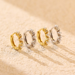 Elegant s925 gold and silver pearl earrings with crystals on beige textured background