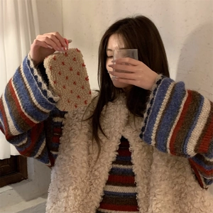 Plush beige pouch with red polka dots shown in a cozy winter lifestyle setting