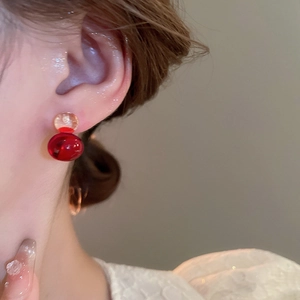 Detail of colorful resin gourd earrings with yellow and red translucent spherical beads