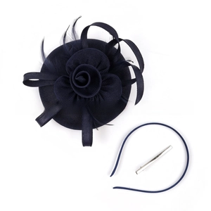 Detail of navy blue flower fascinator set with mesh petals, feathers, headband and clip