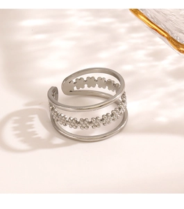 Detail of multi-layer stainless steel ring with hollow clover and beaded flower textures