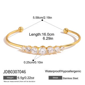 Detailed top view of 18K gold plated stainless steel cuff with white zircon stones
