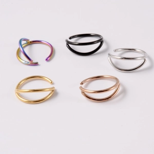 Detailed set of five stainless steel curved nose rings in mixed metallic colors on white