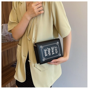 Gothic style book shaped shoulder bag with Little Black Magic Book print and chain