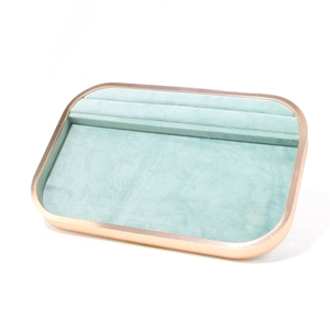 Detailed view of jewelry tray with mint green microfiber lining and golden metal frame