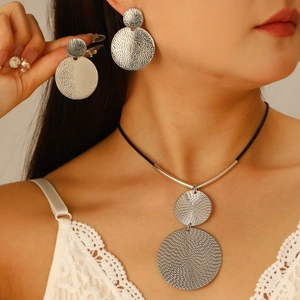 Silver geometric necklace and earrings set with hammered texture on black leather cord
