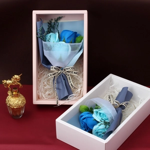 Close-up of blue soap rose bouquets with mesh wrapping and elegant gift box packaging