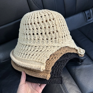Detail of hollow knit sun hats in cream, brown and black colors for summer breathability