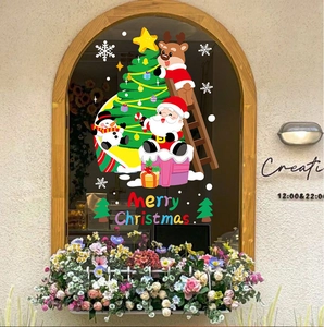 Christmas window stickers with Santa, reindeer and tree on classic arched window pane