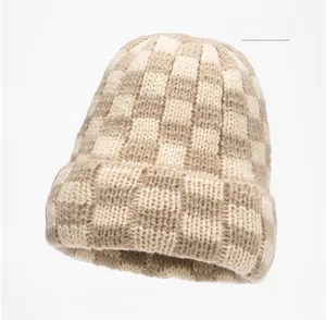 Detail of khaki checkered knit beanie showing thick texture and folded cuff for winter warmth