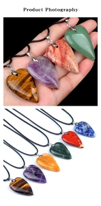 Macro shot of various heart-shaped natural stone pendants on black cords with stone textures