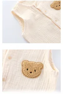 Detail of baby cotton gauze vest with cute bear embroidery and round neckline