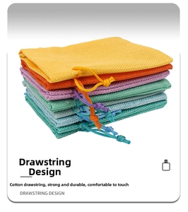 Detail of multi-color cotton linen drawstring pouches with textured fabric and cords