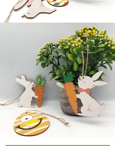 Close-up of wooden Easter egg ornaments and bunny pendants with hanging jute rope