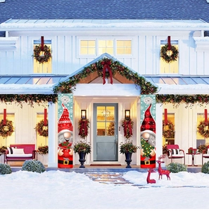 Christmas gnome porch banners with red and black plaid patterns on a snowy villa door